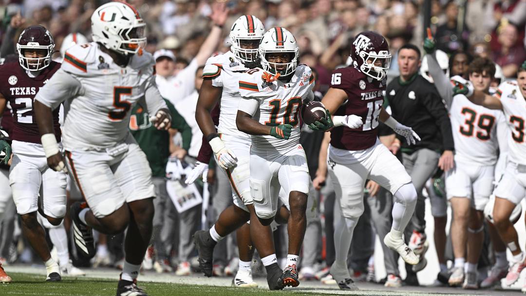 Dec 20, 2025; College Station, TX, USA; Miami Hurricanes wide receiver Malachi Toney (10) returns a punt against the Texas A&M Aggies during first half of the first round game of the CFP National Playoff at Kyle Field. Mandatory Credit: Maria Lysaker-Imagn Images